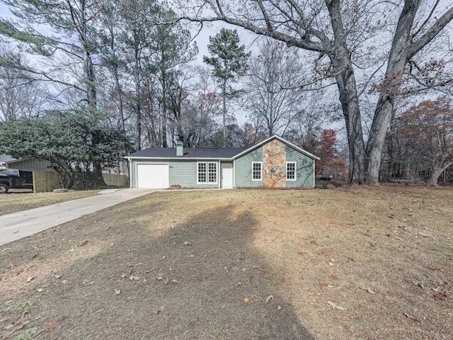 ranch-style home with a front lawn and a garage