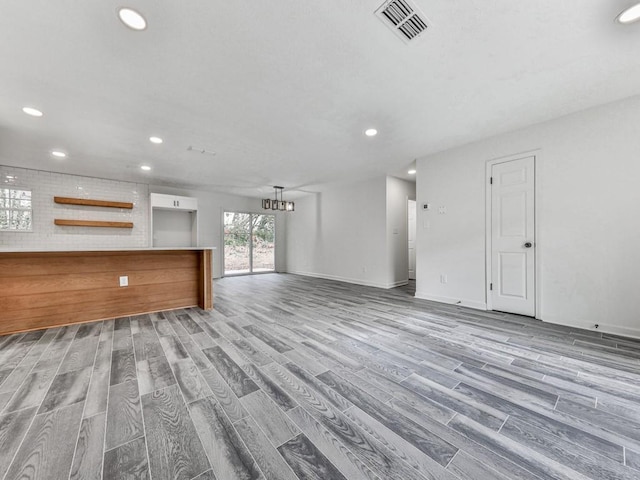 unfurnished living room featuring light wood-type flooring