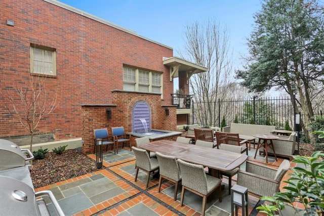 view of patio featuring area for grilling and a fireplace