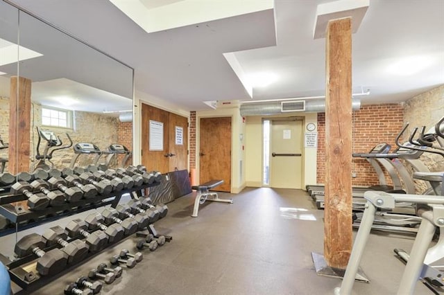 exercise room with brick wall