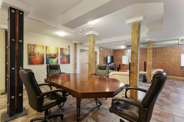 office area with decorative columns and brick wall