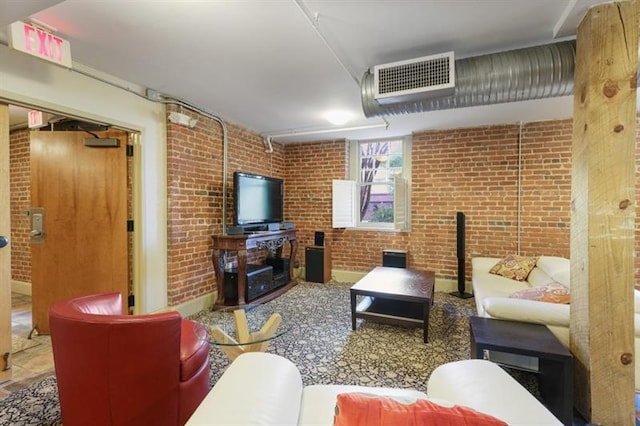 living room featuring brick wall