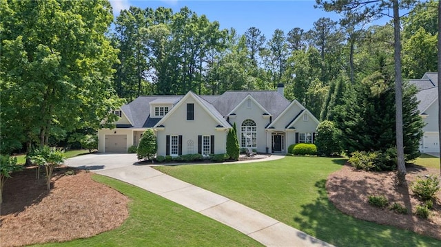 410 Longwood Ln, Alpharetta, GA 30004 - view of front facade with concrete driveway, a garage, a front lawn, a chimney, and stucco siding