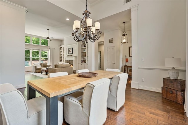 410 Longwood Ln, Alpharetta, GA 30004 - dining space featuring a chandelier, dark wood-style flooring, a lit fireplace, ceiling fan, and baseboards