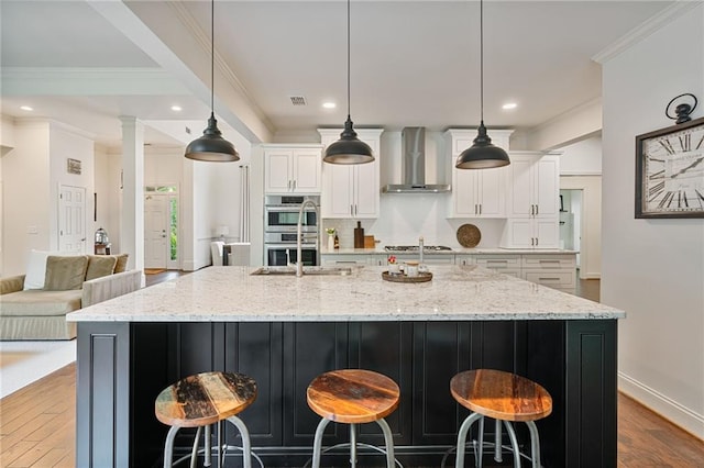 410 Longwood Ln, Alpharetta, GA 30004 - kitchen featuring wall chimney exhaust hood, appliances with stainless steel finishes, white cabinets, dark wood-style flooring, and recessed lighting