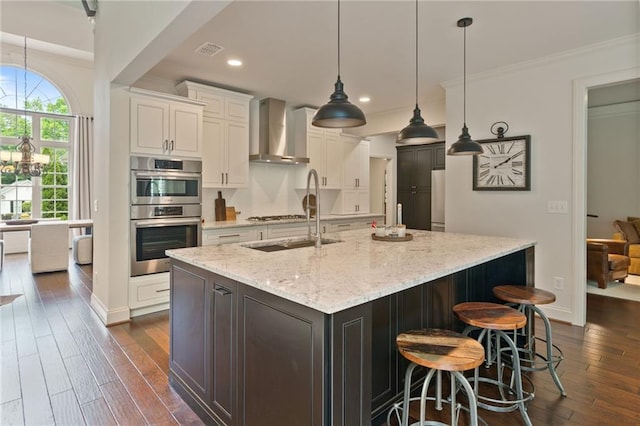 410 Longwood Ln, Alpharetta, GA 30004 - kitchen featuring wall chimney range hood, stainless steel double oven, ornamental molding, white cabinetry, and dark wood-style flooring