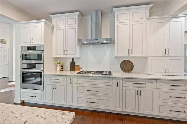 410 Longwood Ln, Alpharetta, GA 30004 - kitchen featuring wall chimney range hood, appliances with stainless steel finishes, white cabinets, light stone counters, and tasteful backsplash