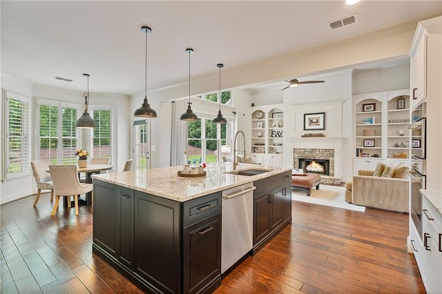 410 Longwood Ln, Alpharetta, GA 30004 - kitchen featuring stainless steel appliances, a sink, a stone fireplace, a ceiling fan, and crown molding