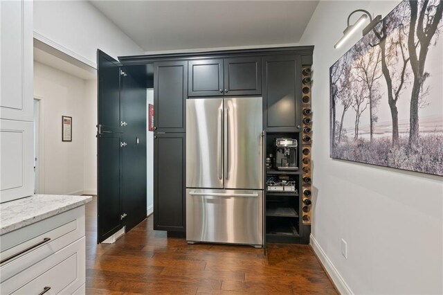 410 Longwood Ln, Alpharetta, GA 30004 - kitchen with freestanding refrigerator, light stone countertops, dark wood-type flooring, and baseboards