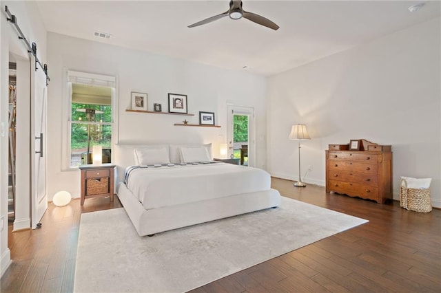 410 Longwood Ln, Alpharetta, GA 30004 - bedroom with a barn door, hardwood / wood-style flooring, and baseboards