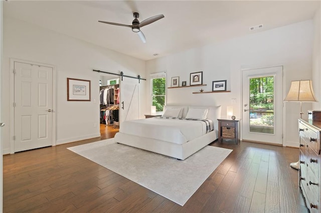 410 Longwood Ln, Alpharetta, GA 30004 - bedroom with a barn door, dark wood-type flooring, ceiling fan, and a spacious closet