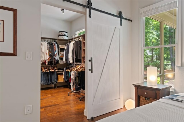 410 Longwood Ln, Alpharetta, GA 30004 - bedroom featuring a barn door, multiple windows, and wood finished floors