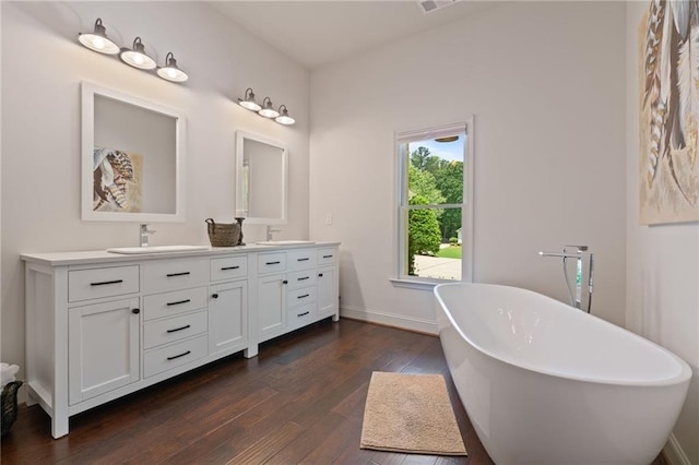 410 Longwood Ln, Alpharetta, GA 30004 - full bath featuring hardwood / wood-style flooring, double vanity, a freestanding bath, and baseboards