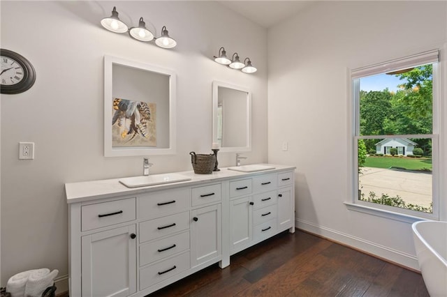 410 Longwood Ln, Alpharetta, GA 30004 - full bathroom featuring double vanity, a freestanding tub, wood finished floors, and baseboards