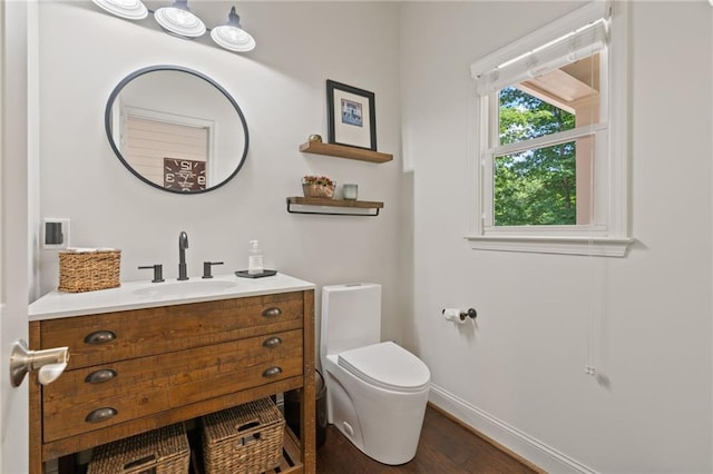 410 Longwood Ln, Alpharetta, GA 30004 - half bathroom with baseboards, toilet, wood finished floors, and vanity