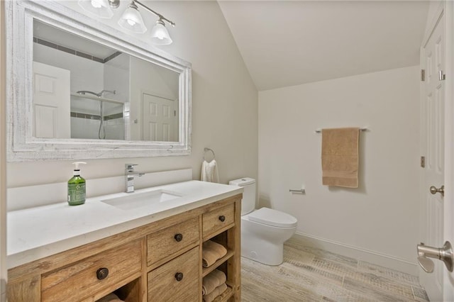 410 Longwood Ln, Alpharetta, GA 30004 - full bath featuring a walk in shower, wood finished floors, vaulted ceiling, vanity, and toilet