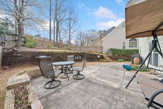 view of patio / terrace with outdoor dining space, area for grilling, and a fenced backyard