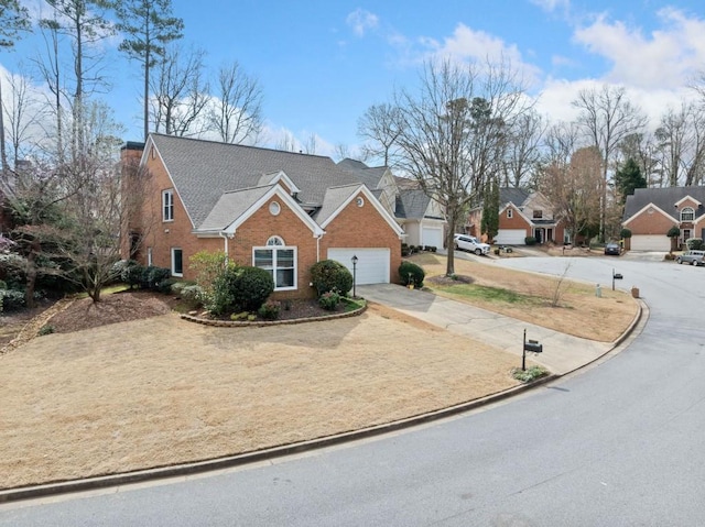 view of front of home with brick siding, a residential view, and driveway