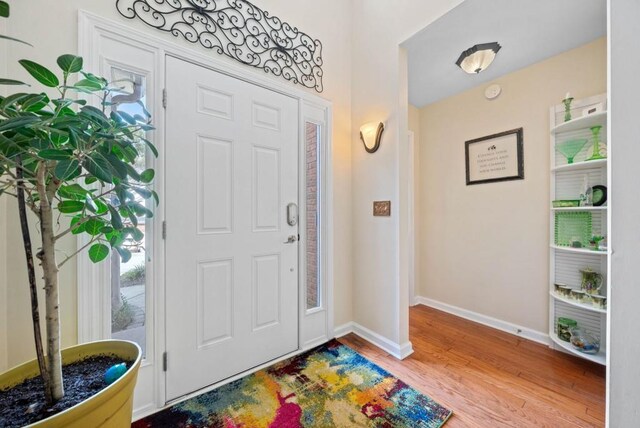 entrance foyer featuring baseboards and wood finished floors