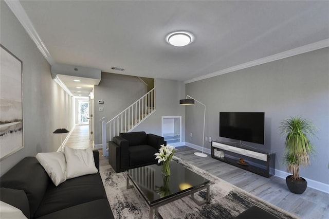 living room with hardwood / wood-style flooring and ornamental molding