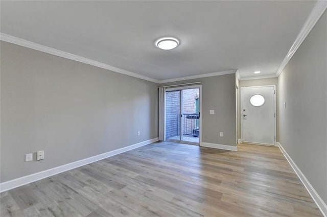 entryway featuring light wood-type flooring and crown molding