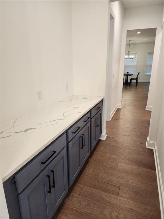 2949 Longbush, Duluth, GA 30097 - bar with dark wood-type flooring, baseboards, a chandelier, and recessed lighting