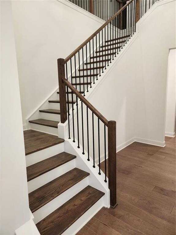 2949 Longbush, Duluth, GA 30097 - stairway with wood finished floors, baseboards, and a towering ceiling