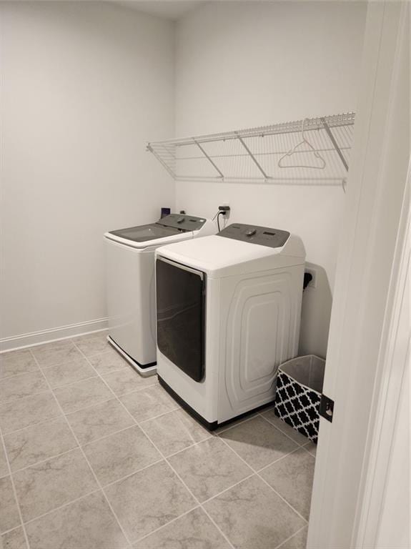 2949 Longbush, Duluth, GA 30097 - washroom featuring washer and clothes dryer, light tile patterned floors, and baseboards