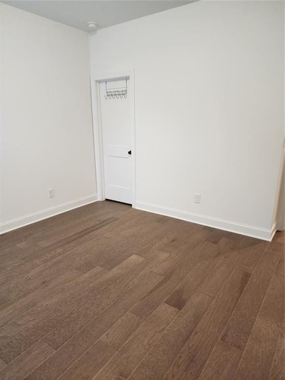 2949 Longbush, Duluth, GA 30097 - spare room featuring dark wood-style flooring, baseboards, and a smoke detector