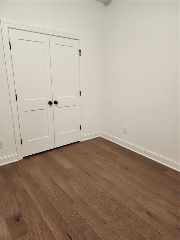 2949 Longbush, Duluth, GA 30097 - unfurnished bedroom featuring dark wood-style floors, baseboards, and a closet