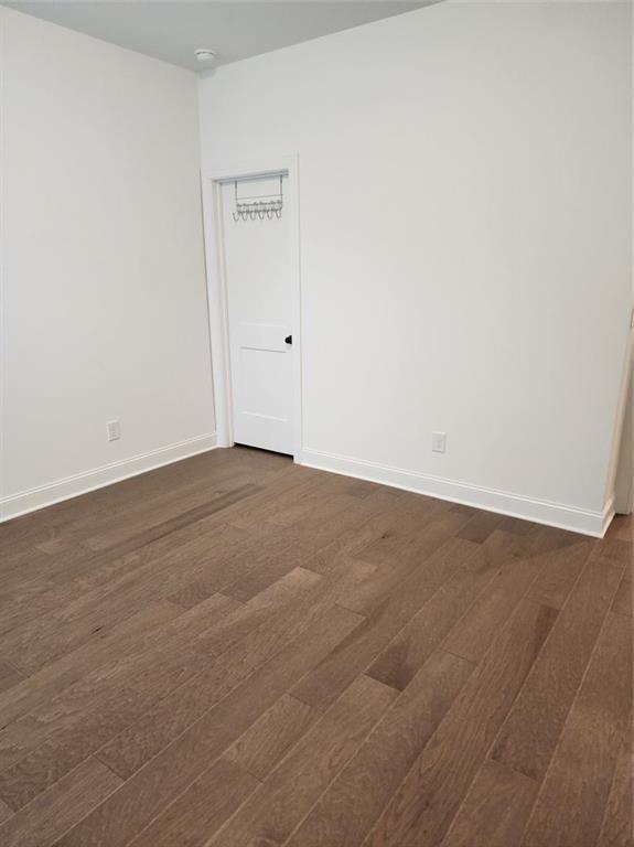2949 Longbush, Duluth, GA 30097 - unfurnished room featuring dark wood-type flooring and baseboards