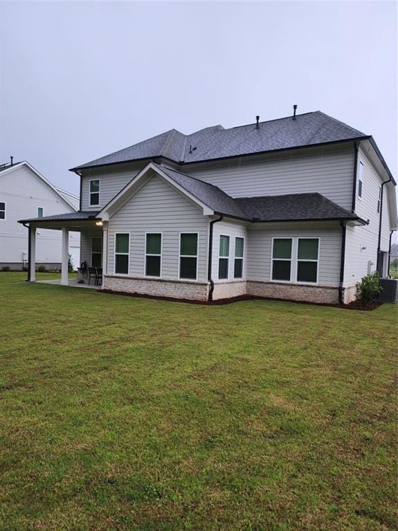 2949 Longbush, Duluth, GA 30097 - rear view of house with brick siding, a yard, a patio, and roof with shingles