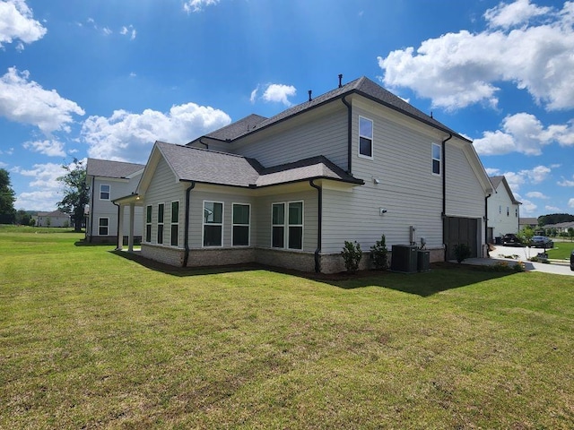 2949 Longbush, Duluth, GA 30097 - view of property exterior featuring a lawn, central air condition unit, brick siding, and a shingled roof