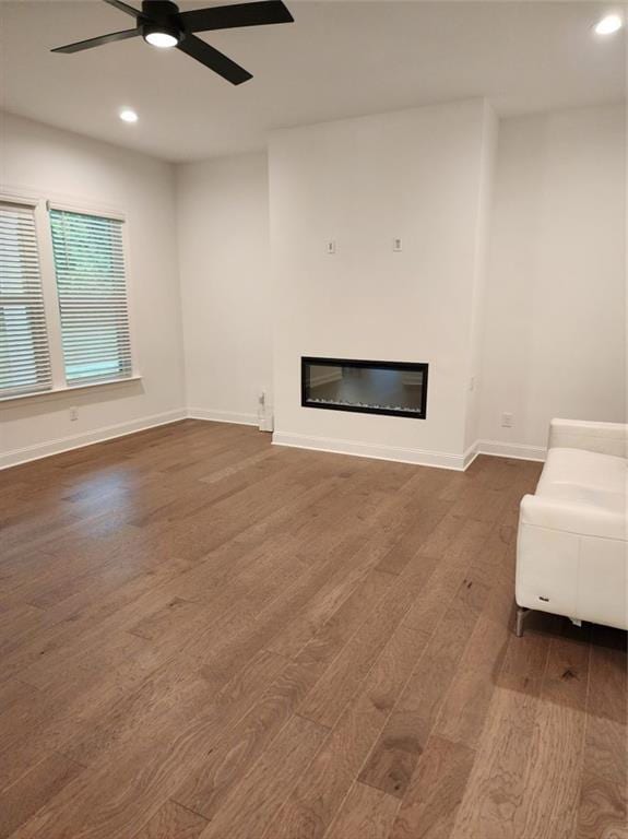 2949 Longbush, Duluth, GA 30097 - living room with wood finished floors, a glass covered fireplace, recessed lighting, ceiling fan, and baseboards