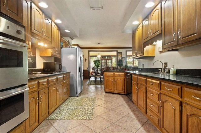 kitchen featuring light tile patterned flooring, sink, kitchen peninsula, appliances with stainless steel finishes, and ornamental molding