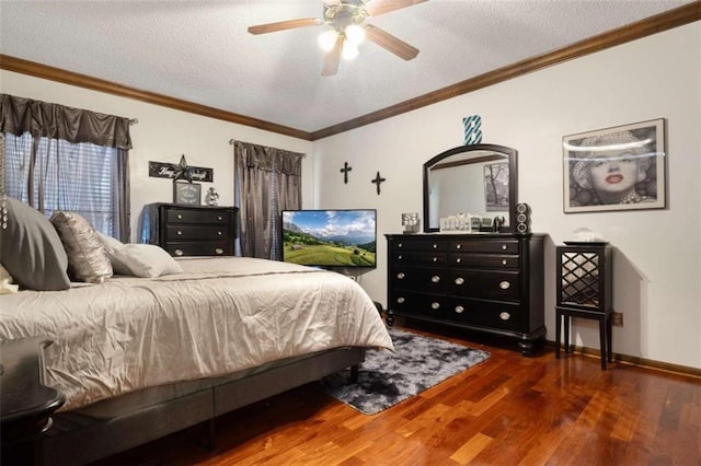 bedroom featuring a textured ceiling, ornamental molding, dark wood-type flooring, and ceiling fan