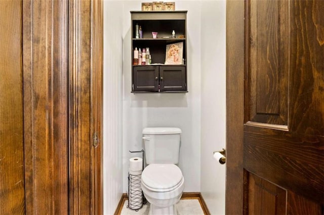 bathroom featuring tile patterned flooring and toilet