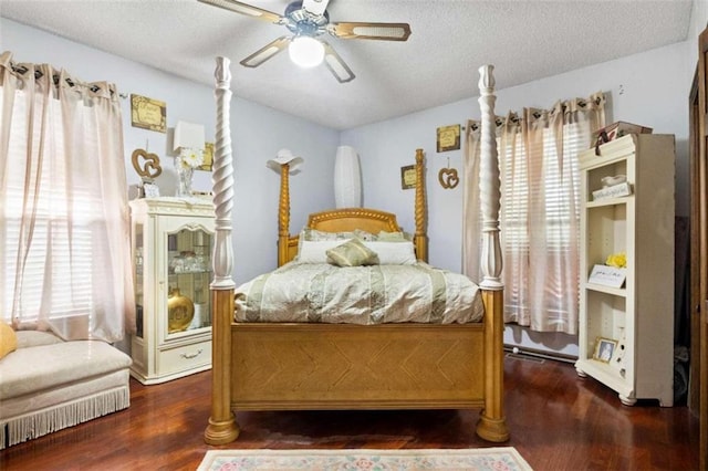 bedroom featuring a textured ceiling, dark hardwood / wood-style flooring, and ceiling fan