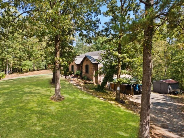 view of front of home with a front lawn and a shed