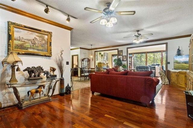 living room with ceiling fan, a textured ceiling, dark hardwood / wood-style floors, and ornamental molding