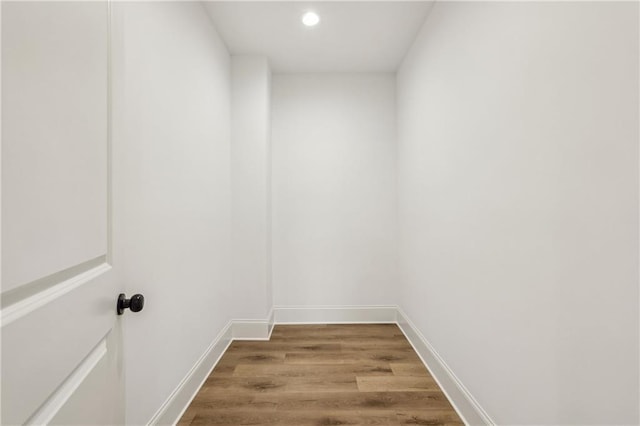 interior space featuring recessed lighting, baseboards, and wood finished floors