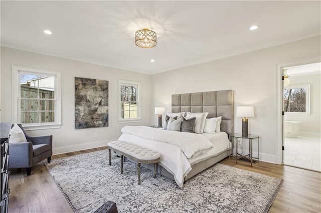 bedroom with recessed lighting, baseboards, wood finished floors, and crown molding