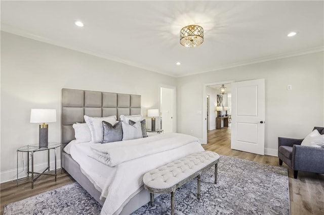 bedroom with recessed lighting, baseboards, wood finished floors, and ornamental molding