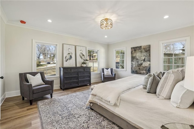 bedroom with crown molding, multiple windows, and wood finished floors