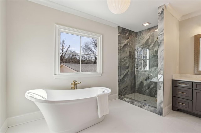 full bath featuring a marble finish shower, baseboards, ornamental molding, a freestanding tub, and vanity