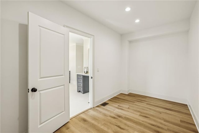 spare room with visible vents, recessed lighting, light wood-type flooring, and baseboards