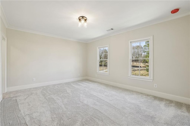 unfurnished room with light carpet, visible vents, baseboards, and ornamental molding