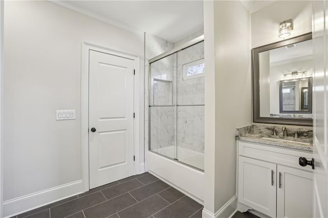 bathroom with baseboards, enclosed tub / shower combo, vanity, and tile patterned flooring