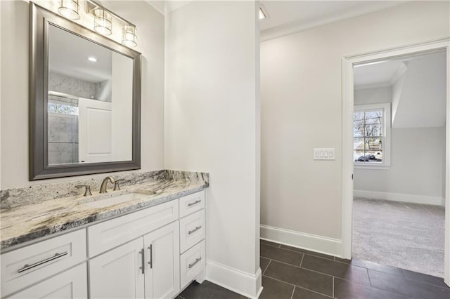 bathroom featuring tile patterned flooring, vanity, and baseboards