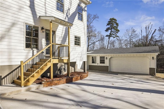 view of exterior entry featuring concrete driveway and a garage